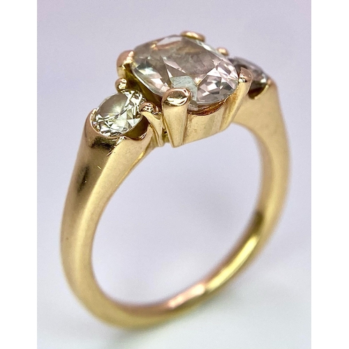 415 - An 18K Yellow Gold and Diamond Ring. 1.5ct oval cut central diamond with 0.15ct diamonds either side... 