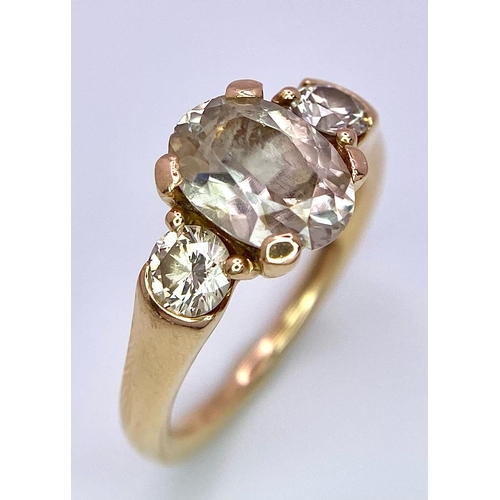 415 - An 18K Yellow Gold and Diamond Ring. 1.5ct oval cut central diamond with 0.15ct diamonds either side... 