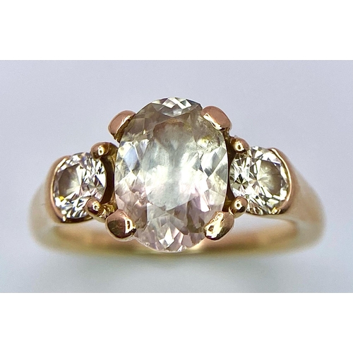 415 - An 18K Yellow Gold and Diamond Ring. 1.5ct oval cut central diamond with 0.15ct diamonds either side... 