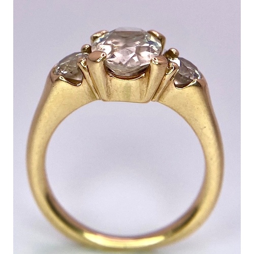 415 - An 18K Yellow Gold and Diamond Ring. 1.5ct oval cut central diamond with 0.15ct diamonds either side... 