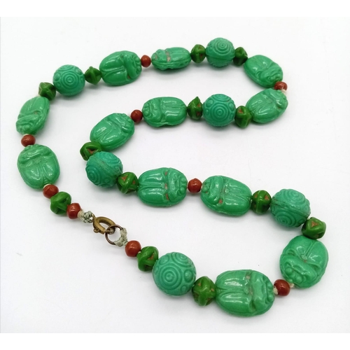 425 - An Antique Chinese Green Turquoise Hand-Carved Necklace. 
With coral spacers. 35cm. 30.33g