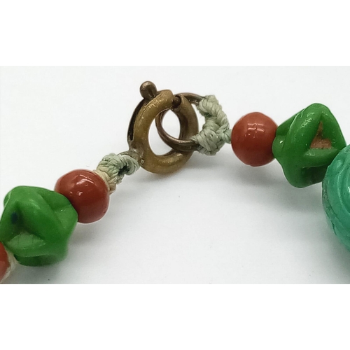 425 - An Antique Chinese Green Turquoise Hand-Carved Necklace. 
With coral spacers. 35cm. 30.33g