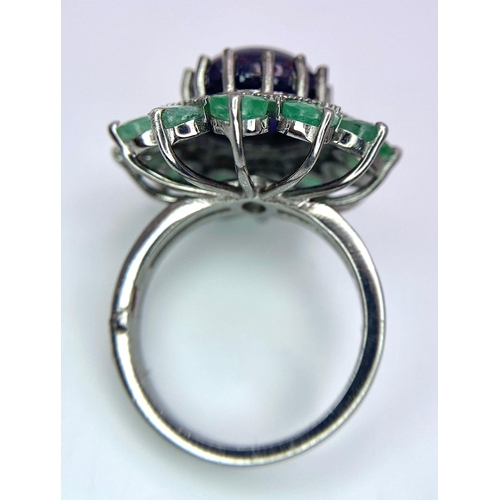 481 - A 7.60Ct Oval Tanzanite Gemstone Ring - with 3ctw Emerald and 0.40ctw Diamond Surrounds. Set in 925 ... 