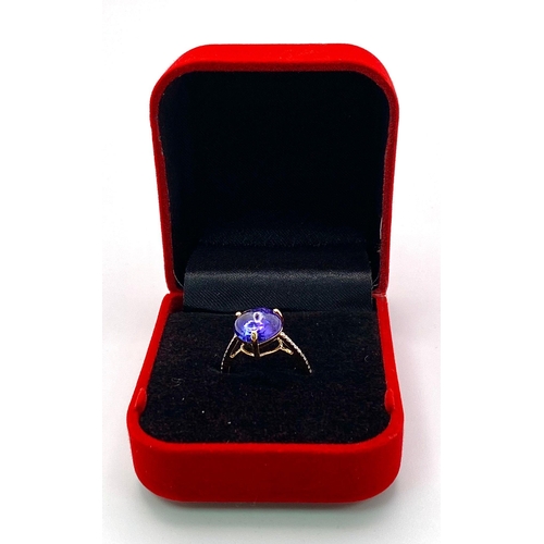 508 - A 14K Yellow Gold Tanzanite Ring. 5ct central tanzanite with 0.10ctw of diamond accents. Size M. 2.6... 