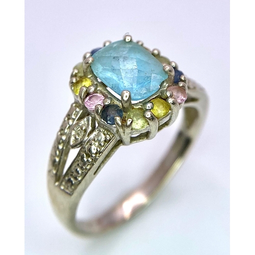 6 - A vintage 9K White Gold blue Topaz solitaire ring with multi-colour Topaz surrounded. Total weight 3... 