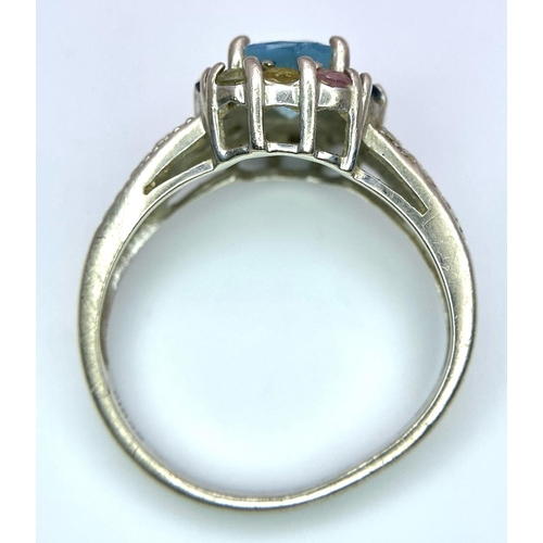 6 - A vintage 9K White Gold blue Topaz solitaire ring with multi-colour Topaz surrounded. Total weight 3... 