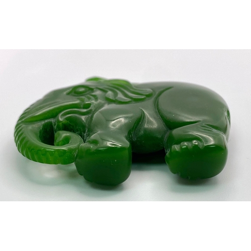 653 - A Chinese Green Jade Elephant Pendant. 5cm x 4cm.