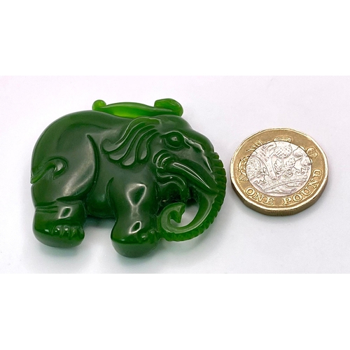 653 - A Chinese Green Jade Elephant Pendant. 5cm x 4cm.