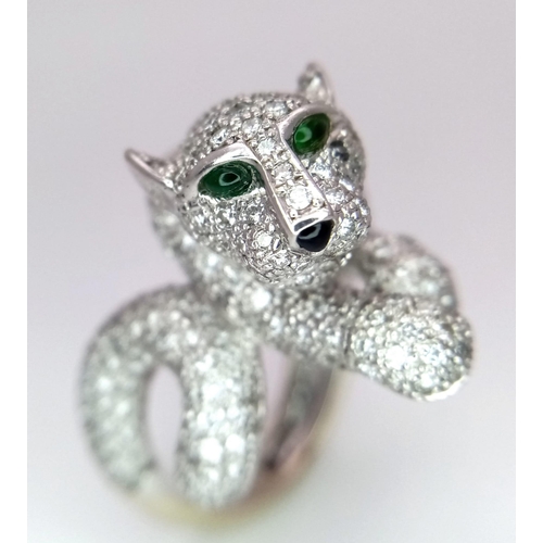 67 - An 18K Gold and Diamond Panther Ring. An encrusted, pave set pouncing Panther with Emerald eyes take... 