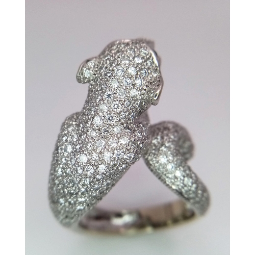 67 - An 18K Gold and Diamond Panther Ring. An encrusted, pave set pouncing Panther with Emerald eyes take... 