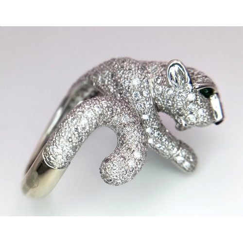 67 - An 18K Gold and Diamond Panther Ring. An encrusted, pave set pouncing Panther with Emerald eyes take... 