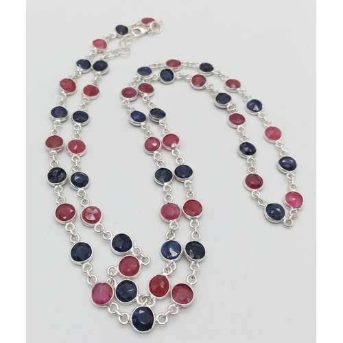 691 - A Ruby and Sapphire Matinee Length Necklace. Circle cut gemstones set in 925 silver. 70cm length. 22... 