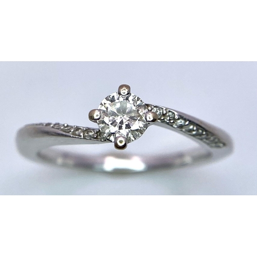 774 - An 18k White Gold Diamond Crossover Ring. 0.25ct approx central stone. Size L. 2.55g total weight. R... 