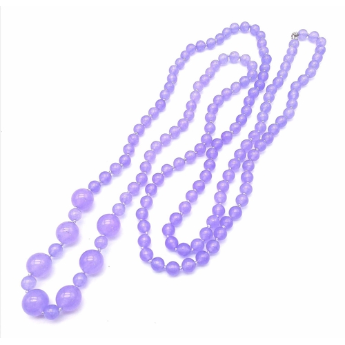 213 - A Lavender Jade Rope-Length Necklace. This 140cm necklace has a vibrant lavender shade with 8mm and ... 