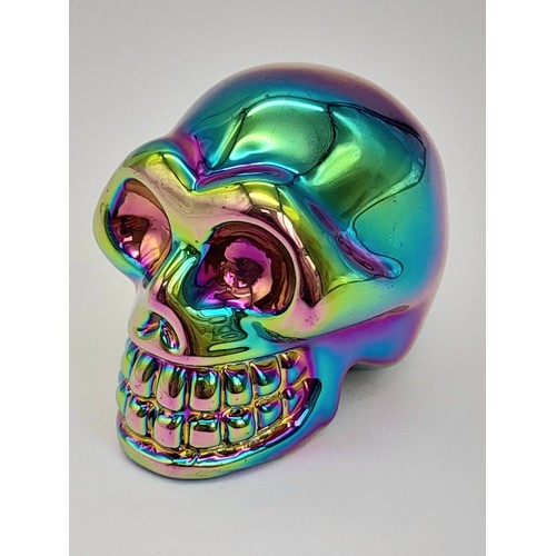 859 - A Crystal Skull Figure with a Titanium Coating. 5cm x 4cm