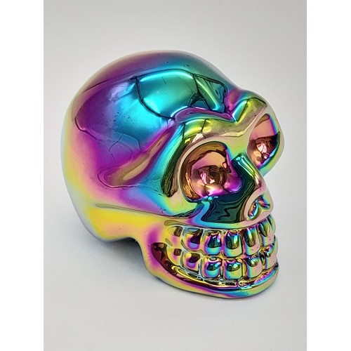 859 - A Crystal Skull Figure with a Titanium Coating. 5cm x 4cm