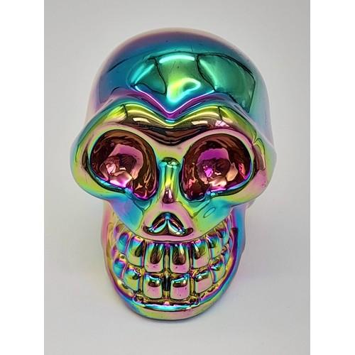 859 - A Crystal Skull Figure with a Titanium Coating. 5cm x 4cm