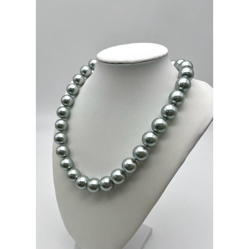 642 - An Attractive Silver South Sea Pearl Shell Bead Necklace. 14mm beads. 42cm necklace length.