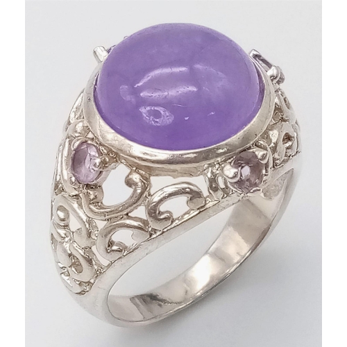 766 - A Vintage Sterling Silver, Filigree Design, 1.3cm Round, Amethyst Cabochon
Ring Size P. Set with a c... 