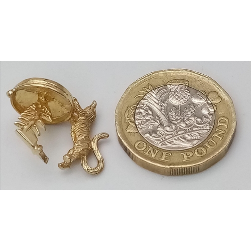 680 - A 9K GOLD CAT WITH FISH BONE CHARM .     3.3gms