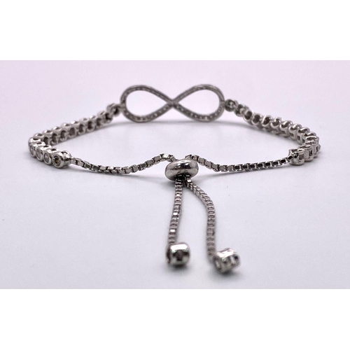 715 - A STERLING SILVER STONE SET INFINITY ADJUSTABLE BRACELET 8.2G
ref: SC 5077