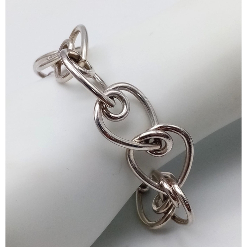 801 - A Sterling silver heart link bracelet 20cm length, 34.5g