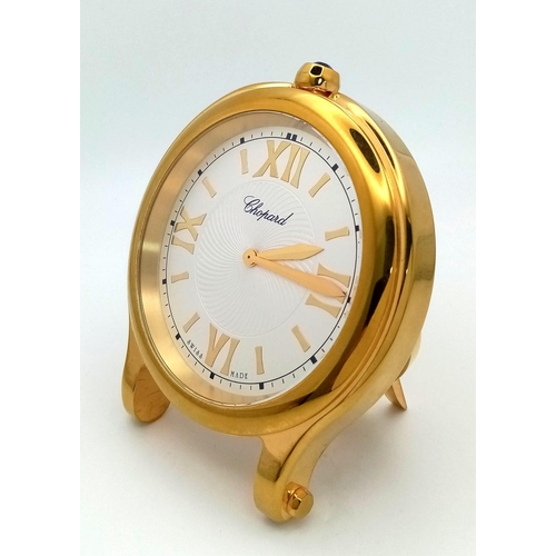 188 - A Chopard Happy Sport Gold Plated Table Clock. Quartz movement. 7.5cm diameter. White dial with Roma... 