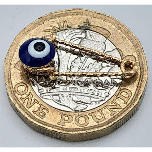 586 - An 18K Gold and Enamel Evil Eye Pendant. 2cm. 0.52g weight.