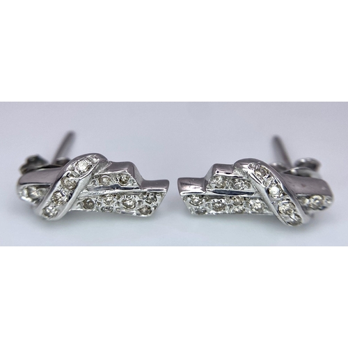 605 - A Pair of 18K Gold and Diamond Earrings. Diamond bow decoration. 3.58g total weight.