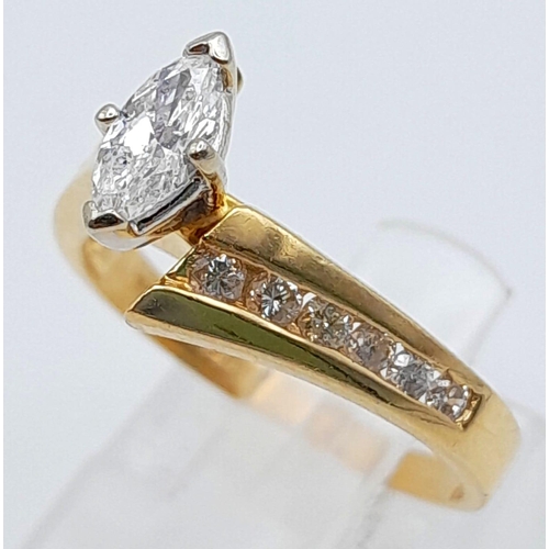 598 - A 14K Yellow Gold Marquise Cut Diamond Crossover Ring. Central marquise cut diamond with six round c... 