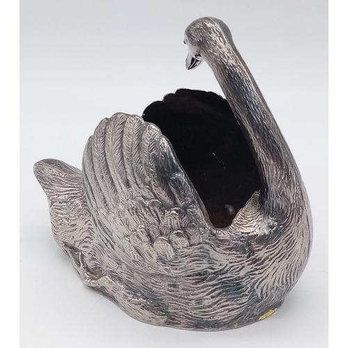 585 - A Silver Plated Swan ornament.
Measures 13cm wide by 11cm tall.