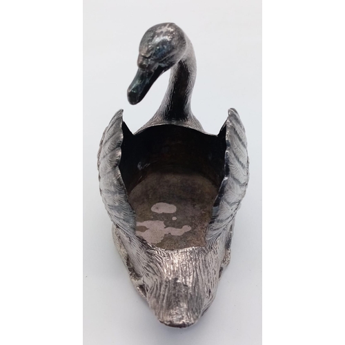 585 - A Silver Plated Swan ornament.
Measures 13cm wide by 11cm tall.