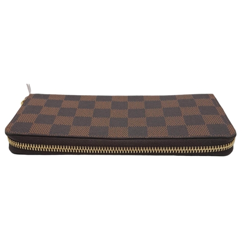 142 - A Louis Vuitton Clemence Wallet. Checked canvas exterior. Zipped and open compartment interior. Come... 