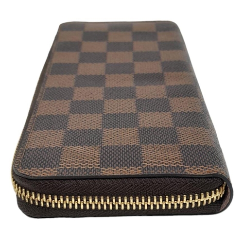 142 - A Louis Vuitton Clemence Wallet. Checked canvas exterior. Zipped and open compartment interior. Come... 