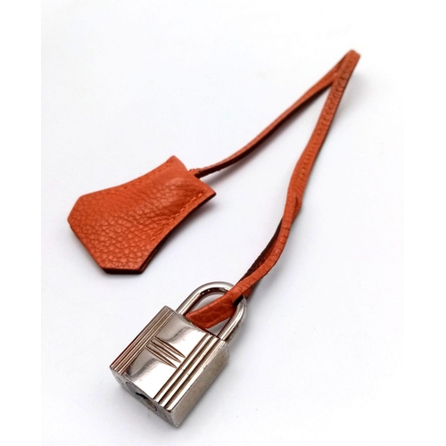 176 - A Hermes Kelly Orange Leather Bag. Textured burnt orange leather exterior. Open and zipped interior ... 