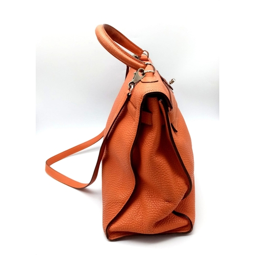 176 - A Hermes Kelly Orange Leather Bag. Textured burnt orange leather exterior. Open and zipped interior ... 