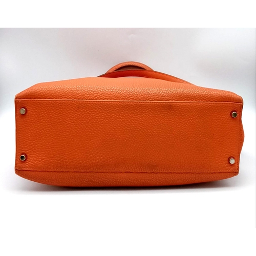 176 - A Hermes Kelly Orange Leather Bag. Textured burnt orange leather exterior. Open and zipped interior ... 