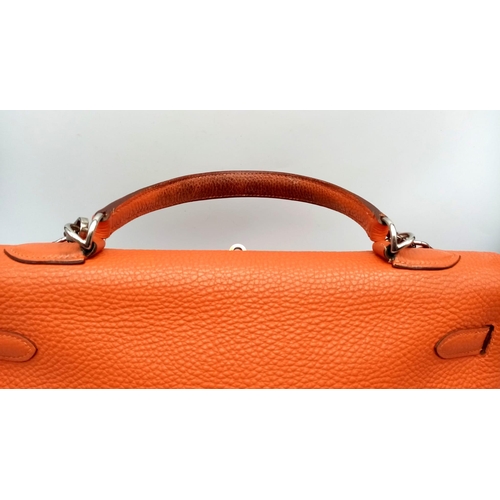 176 - A Hermes Kelly Orange Leather Bag. Textured burnt orange leather exterior. Open and zipped interior ... 