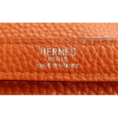 176 - A Hermes Kelly Orange Leather Bag. Textured burnt orange leather exterior. Open and zipped interior ... 