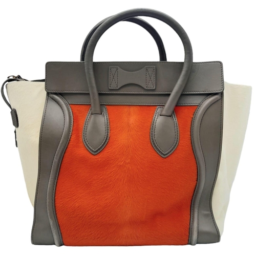 234 - A Celine Leather and Calf-Hair Tote/Luggage Bag. Orange and ivory trimmed calf-hair exterior with zi... 