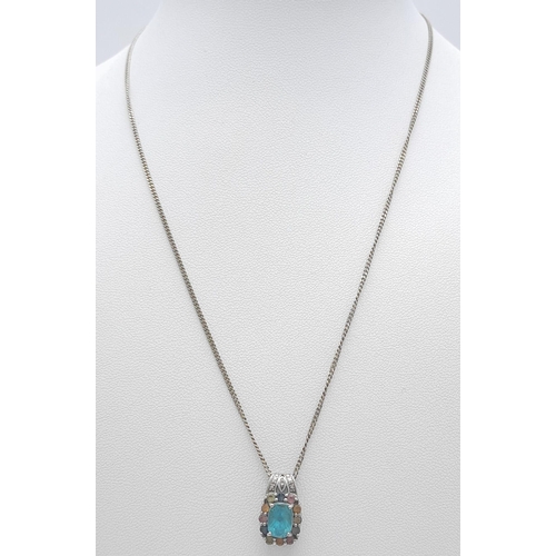 27 - A vintage 9K white gold multi-colour Topaz pendant on 9k gold chain. Total weight 4.3G. Total length... 