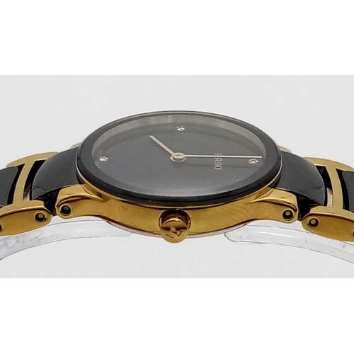 361 - A Rado Centrix Quartz Diamond Watch. Ceramic and gold tone bracelet. Case - 23mm. Black dial with fo... 