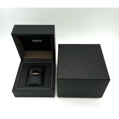 361 - A Rado Centrix Quartz Diamond Watch. Ceramic and gold tone bracelet. Case - 23mm. Black dial with fo... 