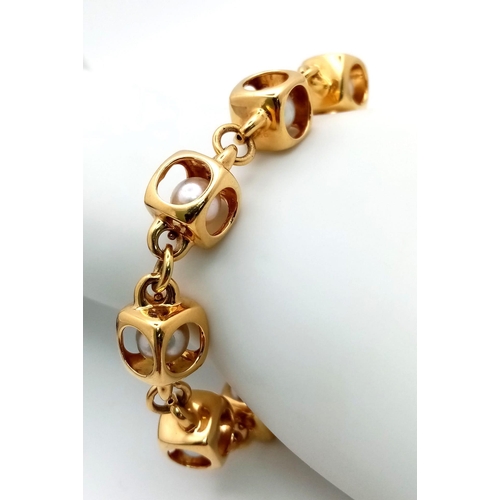 459 - A Designer (Gio Caroli) 18K Yellow Gold and Pearl Bracelet. Nine beautiful South Sea pearls - each e... 