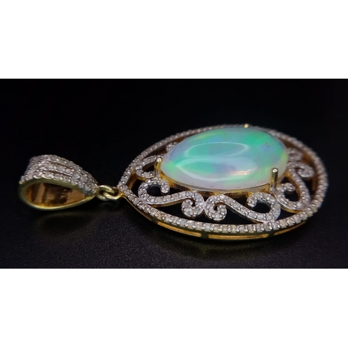 528 - A 10ct Colour-Play Opal Gemstone Pendant with 0.84ctw of Diamond Accents. Set in 925 Silver. Comes w... 