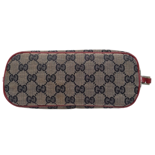 557 - A Gucci Monogram Hobo Cloth Mini Bag. 24cm by 11cm. In good condition but please see photos. Ref: 15... 