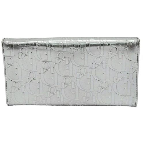 675 - A Christian Dior Metallic Tone Monogram Clutch Bag. Comes with dust cover. 19cm x 11cm. Please see p... 