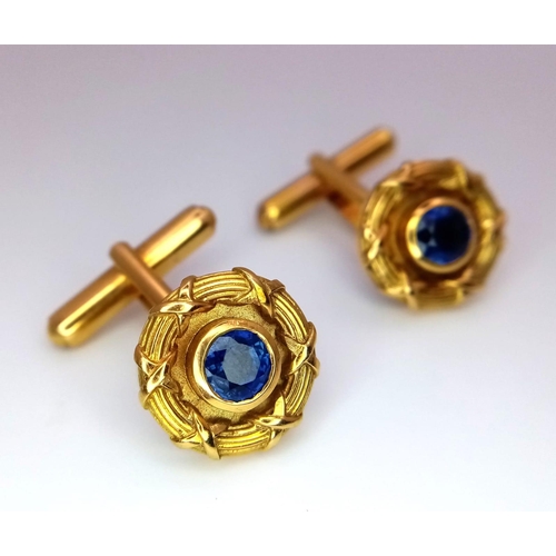 753 - A Pair of Designer Theo Fennell 18K Yellow Gold and Sapphire Cufflinks. Central round cut sapphire w... 