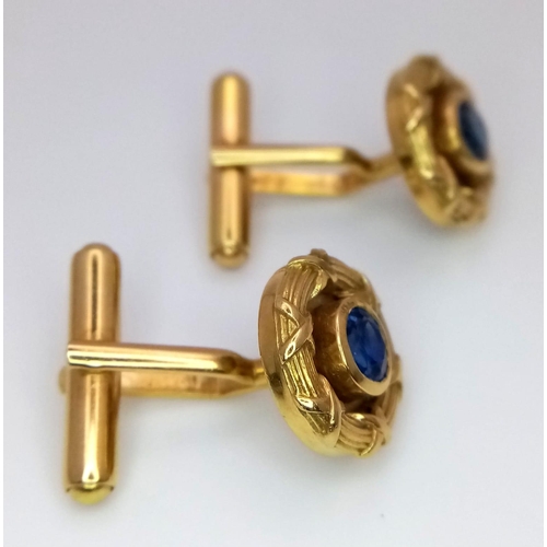 753 - A Pair of Designer Theo Fennell 18K Yellow Gold and Sapphire Cufflinks. Central round cut sapphire w... 