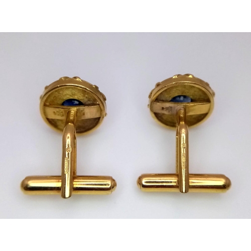 753 - A Pair of Designer Theo Fennell 18K Yellow Gold and Sapphire Cufflinks. Central round cut sapphire w... 